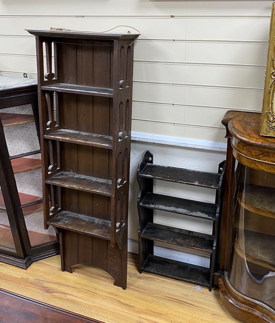 An Art Nouveau oak narrow open bookcase, height 142cm together with a smaller pine wall bracket